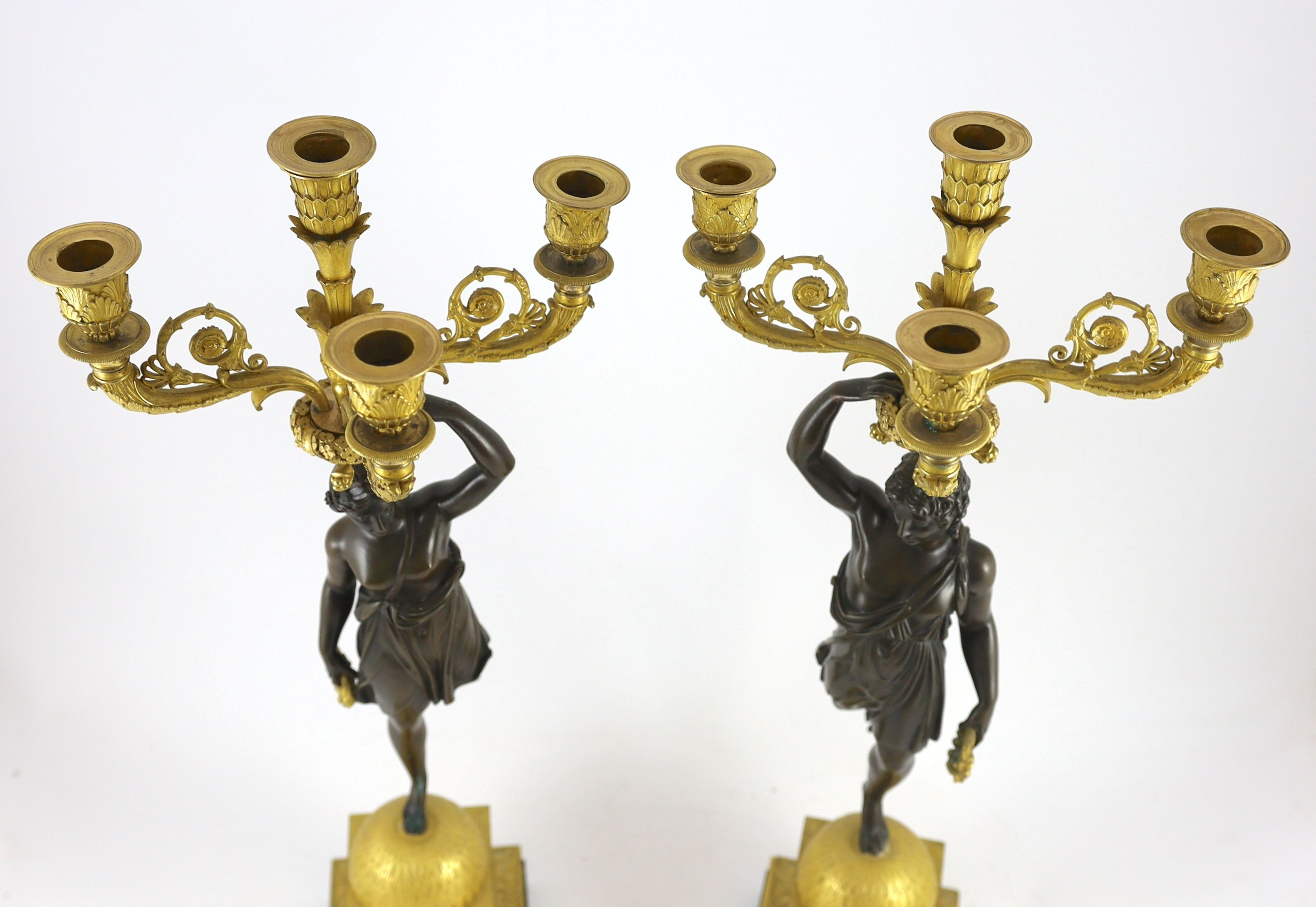 A pair of 19th century French Empire style bronze and ormolu four light candelabra, 25cm wide, 68cm high